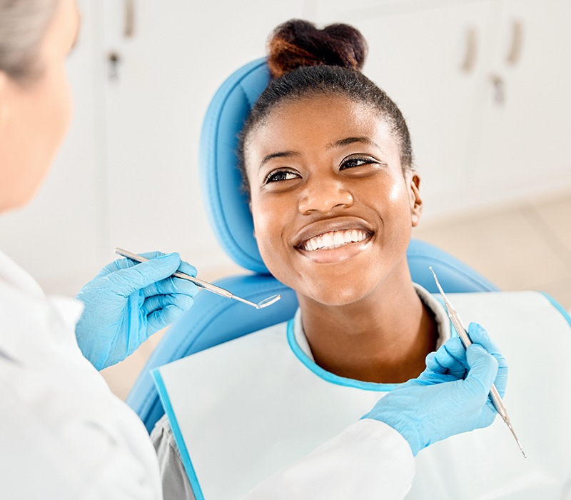 Happy patient looking up at her dentist