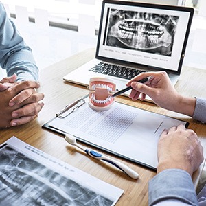 a dentist and patient reviewing an X-ray