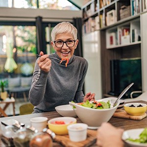 Mature woman eating a delicious salad