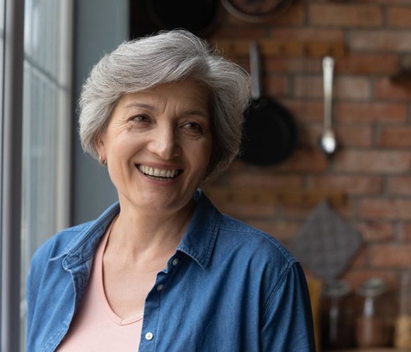 a woman smiling with brand-new dentures